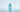 Bottle of Sachajuan Ocean Mist Volume Shampoo on light blue water background.
